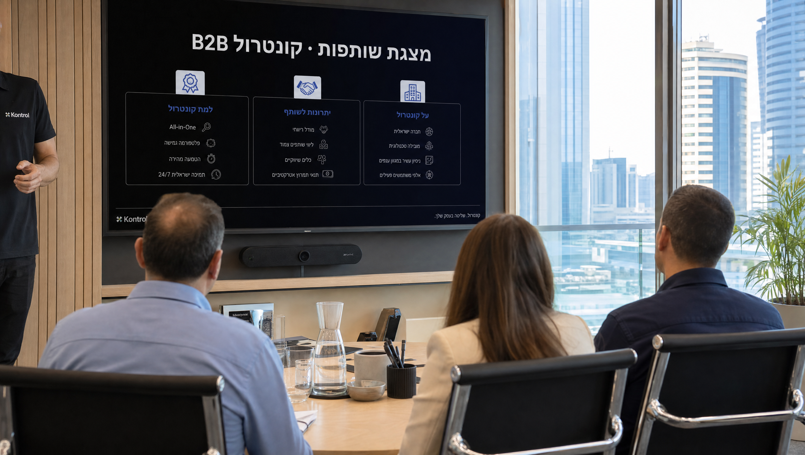 Real photo of the Kontrol Ashdod ops team — 3-4 staff at warehouse / install-staging area, real workwear, daylight, candid not staged. NOT corporate stock; this is the actual team that ships institutional projects.